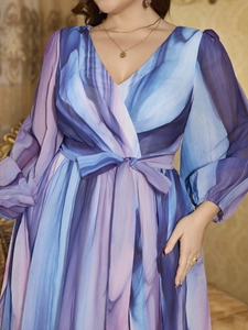 Close-up of V-neck chiffon dress with abstract marble print and waist tie detail