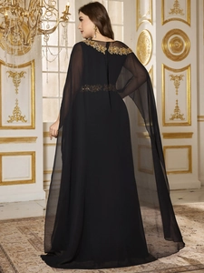 Detailed embroidery on black chiffon evening gown with elegant sheer shawl design