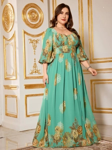 Detail of teal chiffon dress featuring floral patterns, lantern sleeves and high waist