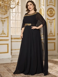 Detail view of exquisite golden floral embroidery on a black chiffon evening gown