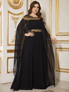 Detail of elegant black chiffon evening gown featuring exquisite golden floral embroidery