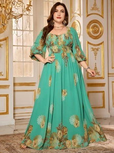 Close-up of elegant mint green chiffon maxi dress featuring golden floral mandala print