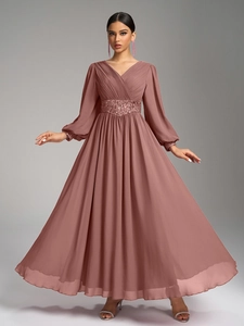 Détail du corsage plissé en V et des perles pailletées sur la robe en mousseline rose