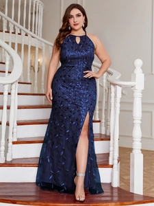 Detail view of the deep blue halter evening gown featuring leaf embroidery and side slit