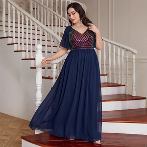 Close-up of elegant V-neckline with colorful sequins and ruffled chiffon sleeves