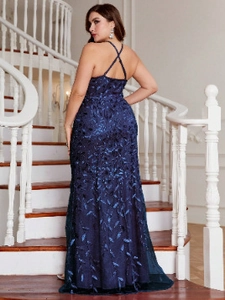 Detail of navy blue sequin embroidery and crisscross backless design on a long evening gown