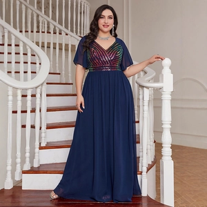 Elegant plus size navy evening gown with sequin V-neck and chiffon skirt on stairs