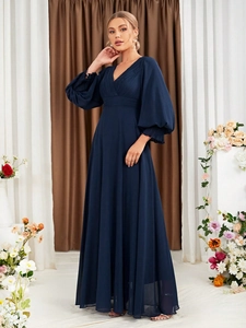 Detail of navy blue V-neck evening dress featuring lantern sleeves and pleated high waist