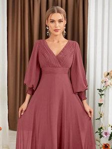 Detail of V-neck dusty pink chiffon evening gown with pleated waist and lantern sleeves