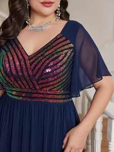 Detail of navy blue V-neck dress featuring colorful sequins and elegant chiffon sleeves