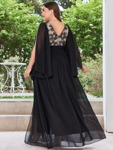 Detail of plus size black evening gown featuring elegant cape sleeves and floral lace back