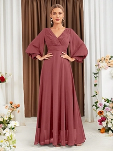 Detailed view of the V-neck bodice with pleated fabric and elegant lantern sleeves on dress