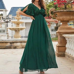 Close-up of dark green V-neck sequined bodice and split cape sleeves on long evening gown