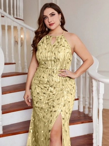 Detailed embroidery on a pale gold halter evening gown with sequins and side slit