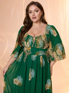 Detail of plus size green chiffon dress showing elegant floral prints and puff sleeves