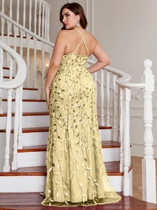 Detail of cross back straps and golden sequin leaf embroidery on yellow evening gown