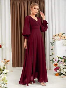 Close-up of elegant burgundy V-neck evening gown with pleated details and lantern sleeves
