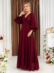 Detailed view of elegant burgundy V-neck maxi dress with long puff sleeves and pleated bodice