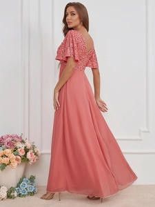 Detail of coral pink sequin bodice and deep V-back design on an elegant chiffon maxi dress