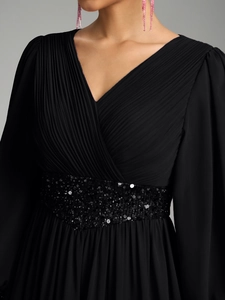 Détails du corsage plissé en V et de la ceinture à paillettes sur robe en mousseline noire