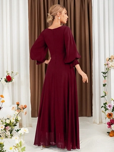 Detailed back view of a burgundy long-sleeved evening gown with lantern sleeves