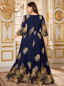 Detailed back view of dark blue chiffon dress with golden floral print and zipper