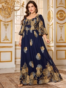 Close-up of navy blue plus size chiffon dress with yellow floral print and lantern sleeves