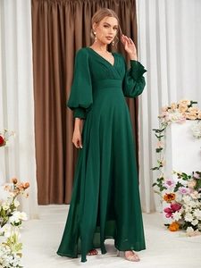 Detail of dark green V-neck evening gown showing pleated chest and elegant lantern sleeves