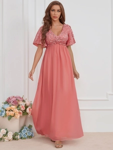 Detail of coral pink V-neck evening gown featuring sequined ruffles and chiffon skirt