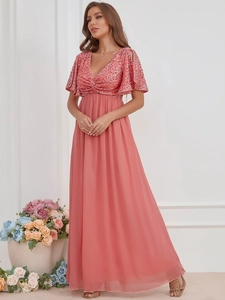 Detail of coral pink evening dress featuring sequin bodice and pleated chiffon skirt
