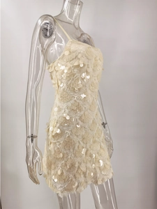 Detail view of cream white sequins on the mesh fabric of a bodycon camisole dress