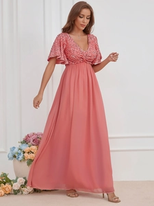 Detail of pink sequined V-neck bodice and flowing chiffon skirt on elegant evening gown