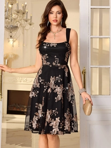 Detail of rose gold sequin floral embroidery on a black mesh party evening dress