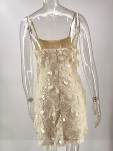 Detail of the back hidden zipper and heavy sequin texture on this cream party dress