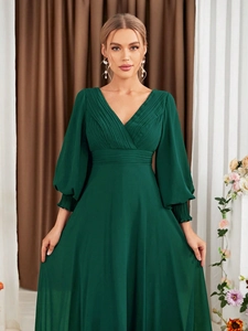 Detail of elegant V-neck dark green chiffon evening dress with pleated waist and puff sleeves