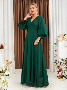 Detail of elegant dark green V-neck evening dress with lantern sleeves and floor-length hem
