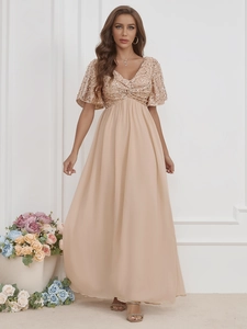 Detailed view of champagne sequined bodice and V-neckline on this elegant maxi evening dress