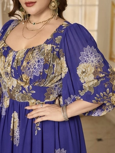 Detail of square neck and vintage floral pattern on blue chiffon dress with puff sleeves