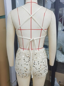 Detailed back view of sequined halter top and shorts set with thin cross back straps