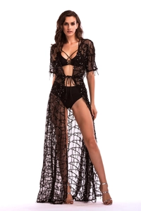 Close-up of black mesh beach cover-up featuring shimmering sequins and a waist tie