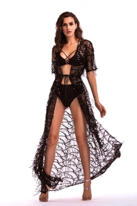 Detail of a black sequined sheer mesh cover-up dress with tassels and waist tie
