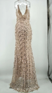 Détail de la robe à paillettes champagne montrant le dos nu et les motifs de vagues