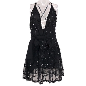 Sexy black sequin mini dress with deep V-neck and halter straps for party or evening events