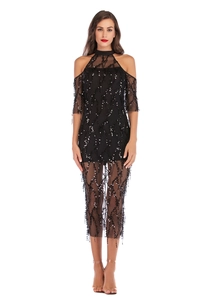 Detail of black sequin dress featuring off-the-shoulder mesh and tassel embroidery patterns