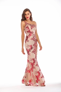 Detail of sequins embroidery on beige one-shoulder evening gown with high side slit