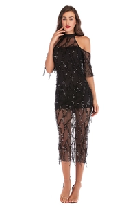 Close-up of black mesh evening dress featuring shimmering sequins and elegant tassel details