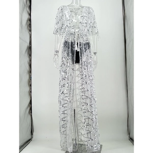 Close-up of white mesh cover-up featuring silver sequins and elegant waist tie design