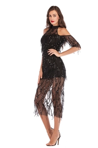 Close-up of black sequined dress with mesh tassels and cold-shoulder details for parties