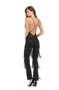 Back view of black sequined jumpsuit featuring crisscross straps and dynamic fringe detail