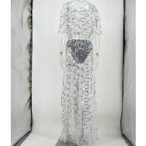 Detailed back view of white sheer mesh dress with shimmering silver sequins in wavy patterns
